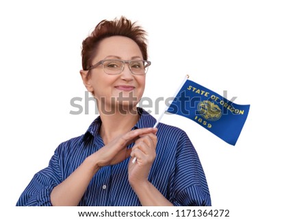 Oregon flag. Woman holding Oregon state flag. Nice portrait of middle aged lady 40 50 years old with a state flag isolated on white background.