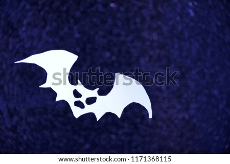 Black halloween flying spooky bat on shiny sparkle blurred background