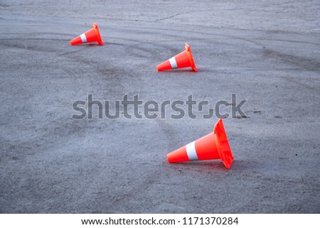 Three a Traffic cone tipped over on the pavement