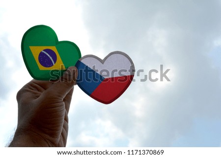 Hand holds a heart Shape Brazil and Czech Republic flag, love between two countries