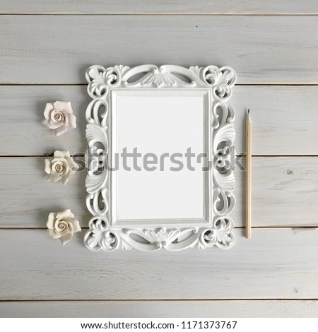 white leaf in vintage frame on a wooden background