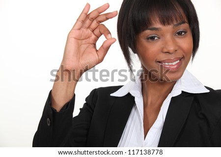 An African American businesswoman gesturing an ok sign.