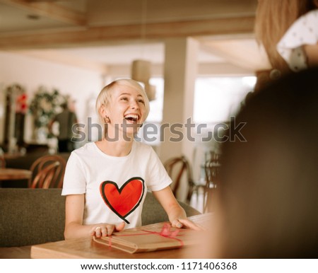 Happy smiling young woman in restaurant