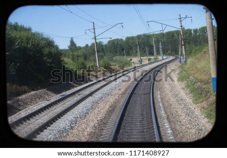 view from train window to rails and railway, train movement, railway