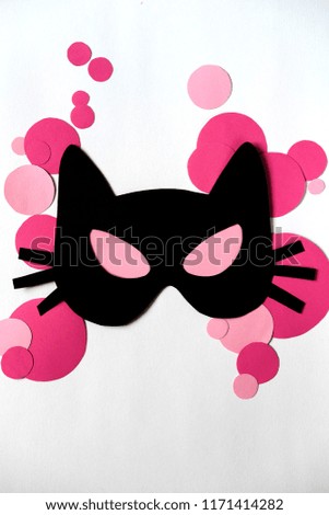 paper cat mask on white background with pink circles. Halloween, carnival, masquerade concept. Vertical