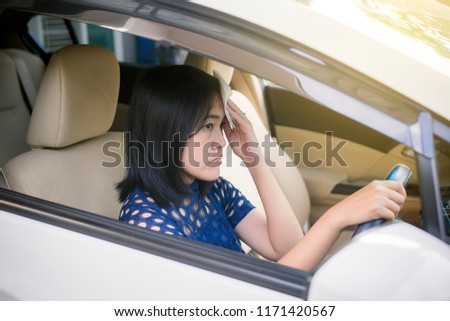 Asian woman suffering heat stroke beacuse a heat wave in her car,Broken air conditioner