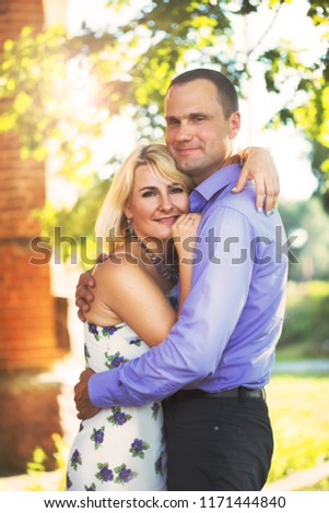 beautiful couple cute hugs at a peeling building peeling sun in summer