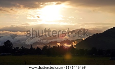 beautiful sunset with fog and clouds in the mountain
