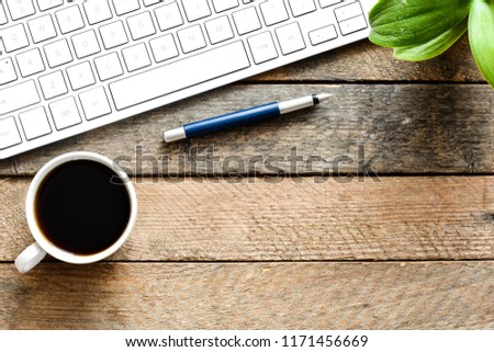 Workplace background with keayboard and coffee on wooden background