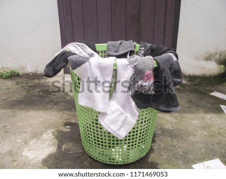 Socks with white and black  put it in a green basket.