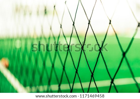 Soccer training net blur on training ground with children