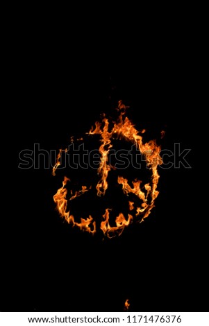 Burning peace symbol over black background