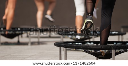 Fitness women jumping on small trampolines,exercise on rebounder Royalty-Free Stock Photo #1171482604