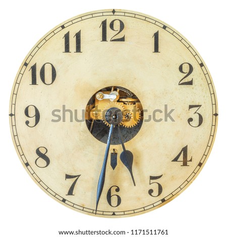 Antique clock with partly open innerworks and gear wheels isolated on a white background
