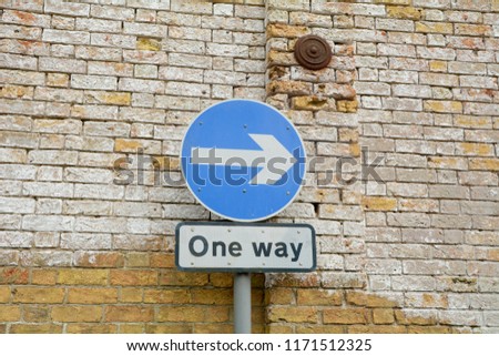 One Way sign with direction arrow