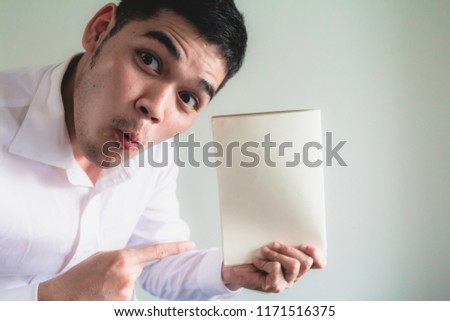 young asian surprise face pointing at paper work on white background