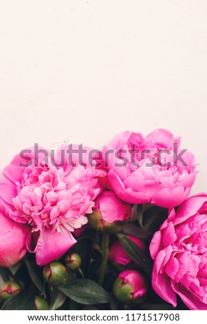 lovely pink peonies on rustic white wooden background, space for text. floral greeting card, flat lay. beautiful peony flowers, tender image. happy mothers or women day concept