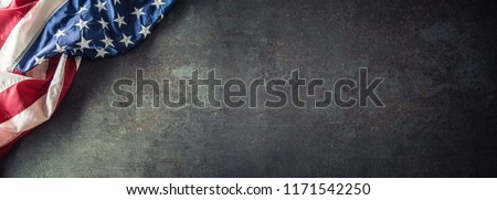 American flag on dark concrete with free space. 4th July Veterans or US Independence day.