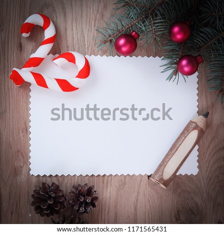 blank Christmas card ,pine cones and pencil on wooden backgroun