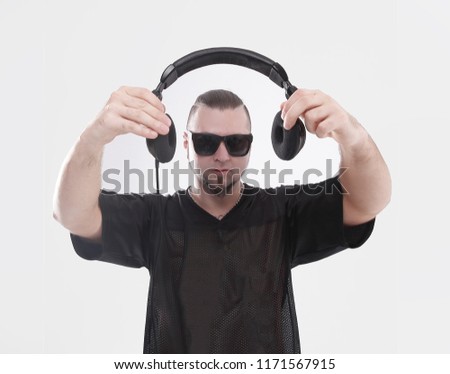 close up. stylish rapper shows headphones .isolated on white