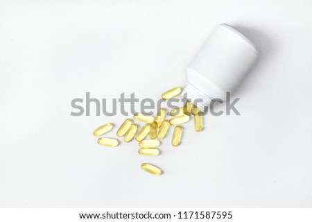 Top view of Gold fish oil isolated on white background. Pile of fish oil. Omega 3. Vitamin E. Flat lay supplementary food view. Salmon fish capsules.