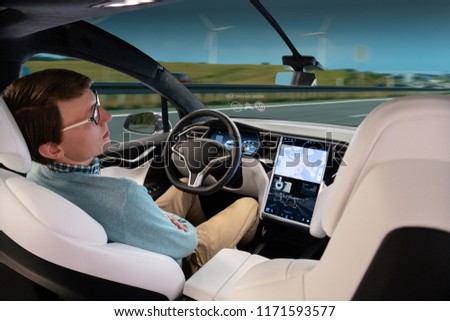 A man sleeps while his car is driven by an autopilot. Self driving vehicle concept Royalty-Free Stock Photo #1171593577