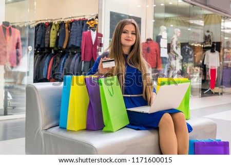 Woman doing online shopping with credit card in hands