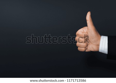 The hand of a businessman shows an excellent mark with a thumb up. Customer experience and satisfaction concept