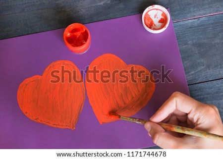 Love concept, drawn heart and red paint.