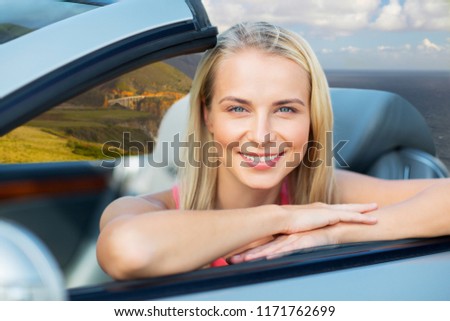 travel, road trip and people concept - happy young woman in convertible car over bixby creek bridge on big sur coast of california background