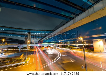 Traffic under highway at night