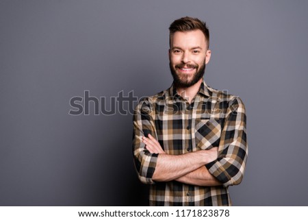 Handsome attractive bearded young smiling brunet men wearing casual, folded hands. Isolated over grey background