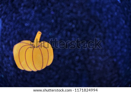 Orange halloween pumpkin on blue sparkle shiny background