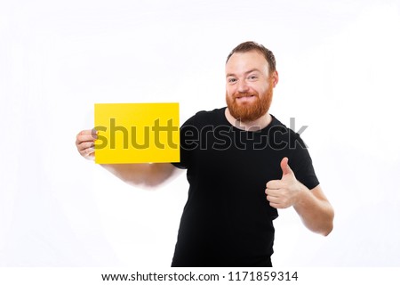 Adult bearded man showing blank yellow sheet and holding thumb up isolated on white background