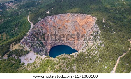 Red Lake (Croatian: Crveno jezero) is a collapse doline (collapse sinkhole) containing a karst lake close to Imotski, Croatia. It is 530 metres deep, thus it is the largest collapse doline in Europe. Royalty-Free Stock Photo #1171888180