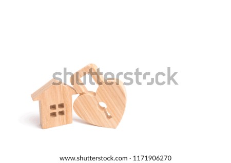 Wooden house with Heart shaped lock on a white background. Love nest, relationships. Buying a house with a young family. Affordable housing. Family psychology, strong relations. Love and offspring