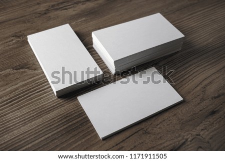 Blank business cards on wood table background. Template for branding identity.