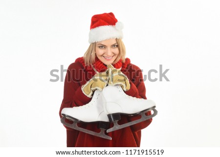 Girl with figure skates. Woman with ice skates for winter ice skating sport activity. Attractive woman with skate shoes. Woman in Santa Claus hat in warm clothing. Female ice skater. Going skating.