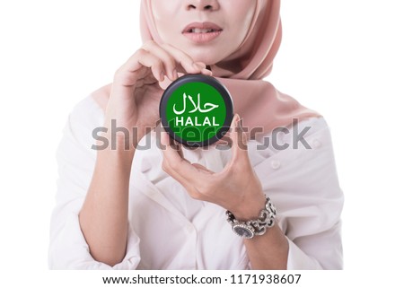 Beautiful women wearing hijab holding halal. Halal certification concept. Sign of halal food.