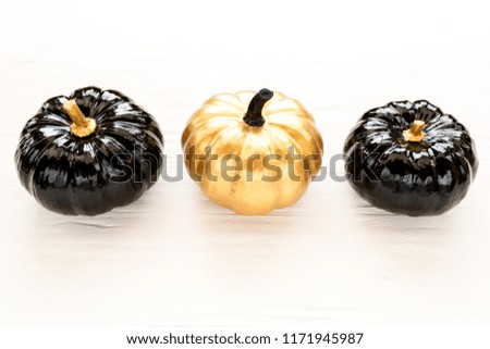 Decorative pumpkin black and gold Halloween isolated on white background. Flat lay, top view.
