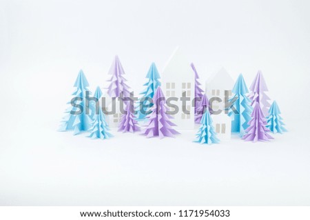 Christmas tree of blue and lilac paper on a white background. Snow white and blue. House of paper craft.