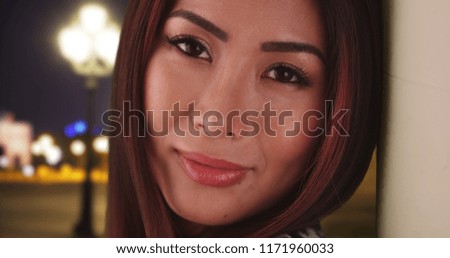 Casual portrait of pretty Asian female outside in evening