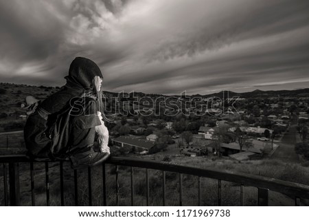 a young assassin in training perched on a guardrail overlooking a city below 