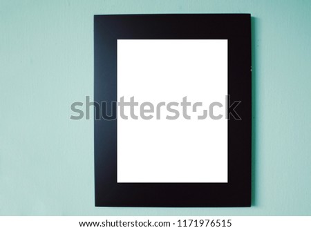 Mock up of black photo frame on green color background.