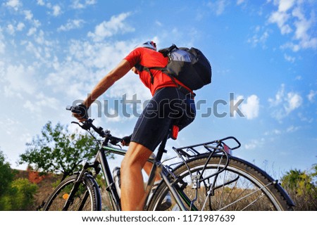 Back view picture of a cyclist riding outdoor