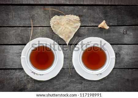 autumn "tea for two" in vintage white cups on a grey rustic wooden table, with autumn leaves and pine needles, view from above Royalty-Free Stock Photo #117198991