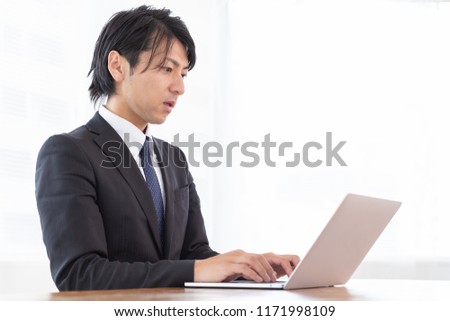 Asian middle age businessman using laptop