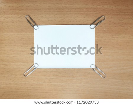 White paper placed on the wood background with space for text.