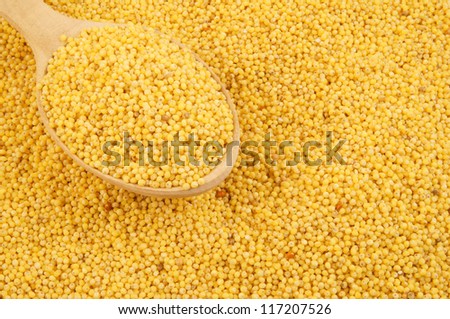 Millet with wooden spoon