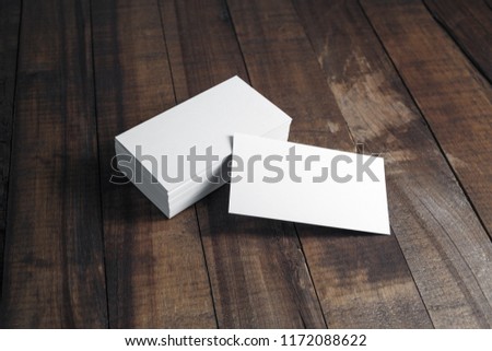 Blank white business cards on wood table background. Mockup for branding identity. Template for graphic designers portfolios.